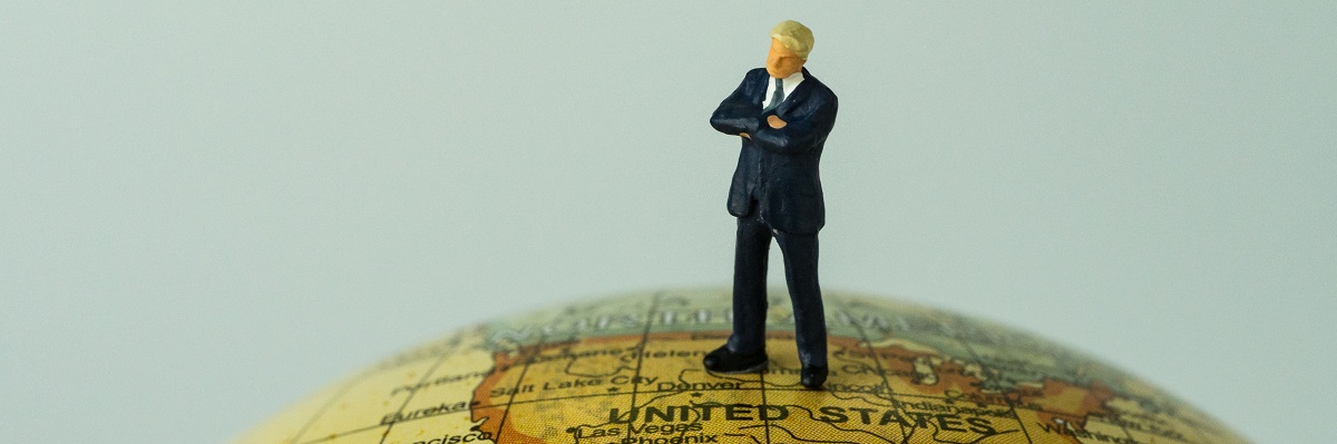 miniature people figure businessman standing on united states of america map on globe as world leader decision concept